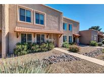 Inviting exterior of a two-story home with a desert landscape and covered entryway at 5905 N 83Rd St, Scottsdale, AZ 85250