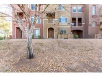 Multi-story condo building featuring colorful facades, private balconies and entryways, and desert landscaping at 900 S 94Th St # 1203, Chandler, AZ 85224