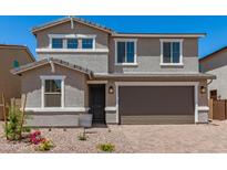 Charming two-story home featuring a two-car garage, landscaped front yard, and neutral color palette at 11615 W Beck Ave, Youngtown, AZ 85363