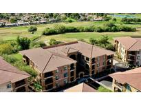 Beautifully landscaped community near golf course with multi-story condo buildings and tile roofs at 11640 N Tatum Blvd # 3048, Phoenix, AZ 85028