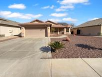 Charming single-story home featuring a two-car garage, well-kept landscaping, and a cozy entrance at 12914 W Wilshire Dr, Avondale, AZ 85392