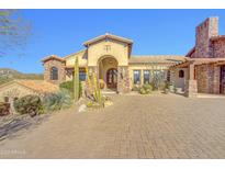 Stunning desert home with a tiled roof, brick driveway, and lush desert landscaping at 14475 E Cortez Dr, Scottsdale, AZ 85259