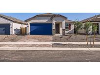 Charming single-story home featuring a stucco facade, blue garage door, and low-maintenance desert landscaping at 15564 W Williams St, Goodyear, AZ 85338