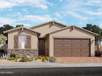 Charming single-story home with a two-car garage, stone accents, and desert landscaping at 3736 S 87Th Dr, Tolleson, AZ 85353