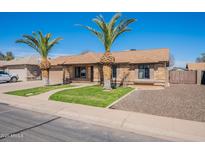 Charming single-story home with well-maintained landscaping and stone accents at 6414 W Monterey Pl, Chandler, AZ 85226