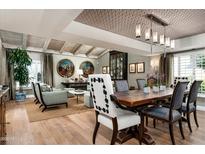Open-concept dining area with hardwood floors, stylish decor, and designer lighting at 8541 N Farview Dr, Scottsdale, AZ 85258
