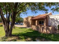 Charming single-story home with a well-maintained lawn and mature trees in a residential neighborhood at 875 S Nebraska St # 37, Chandler, AZ 85225