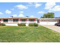 Charming single-story home with well-maintained lawn and attached two-car garage at 10408 N 105Th Ave, Sun City, AZ 85351