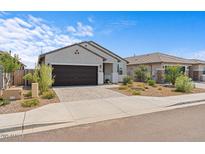 Charming single-story home featuring a two-car garage and a low maintenance landscaped front yard at 13171 W Buckskin Trl, Peoria, AZ 85383