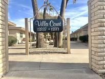 Inviting Villa Court community entrance with lush landscaping and well-maintained grounds at 13801 N 111Th Ave, Sun City, AZ 85351