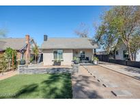 Charming home with a landscaped yard, stone walkway, and neutral stucco exterior at 1926 W Holly St, Phoenix, AZ 85009