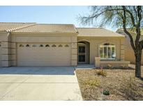 Charming single-story home with a well-maintained front yard and a two-car garage at 2101 S Yellow Wood -- # 92, Mesa, AZ 85209