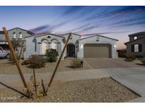 Charming single-story home featuring a neutral color palette, well-kept landscape, and a two-car garage at 24441 N 142Nd Dr, Surprise, AZ 85387