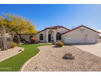 Charming single-story home featuring a well-manicured front yard and a tile roof at 24617 N 49Th Ave, Glendale, AZ 85310