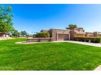 Single Gathering home featuring a well-maintained lawn, desert landscaping, and attached garage at 25261 S Berry Brook Dr, Sun Lakes, AZ 85248