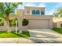 Inviting home exterior with arched entryway, lush lawn, and neutral stucco finish at 7558 N Via De La Luna --, Scottsdale, AZ 85258