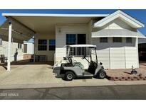 Charming home featuring a covered carport and a golf cart parked in front, perfect for leisure and convenience at 7750 E Broadway Rd # 814, Mesa, AZ 85208