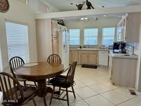 A kitchen featuring ample counter space, appliances, and a breakfast nook set with wooden table and four chairs at 7750 E Broadway Rd # 814, Mesa, AZ 85208