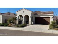 Inviting single-story stucco home with a tile roof, arched entryway, and a two-car garage at 12330 E Crystal Frst, Gold Canyon, AZ 85118