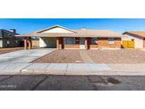 Charming single-story brick home with a covered carport and low-maintenance landscaping at 1322 S Oracle --, Mesa, AZ 85204