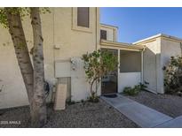 Two story stucco exterior with desert landscaping and gated front porch entry at 15801 N 29Th St # 11, Phoenix, AZ 85032