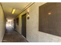 Building exterior shows unit door with security screen and stucco detail at 18202 N Cave Creek Rd # 134, Phoenix, AZ 85032