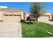 Charming single-story home with desert landscaping, paired garages, and a welcoming entrance at 19427 N 84Th Ave, Peoria, AZ 85382