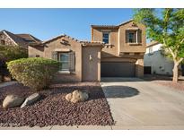 Charming stucco home featuring a well-manicured yard and a two-car garage at 2134 E Honeysuckle Pl, Chandler, AZ 85286