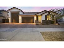 Charming single-story home with a three-car garage and stylish desert landscaping at 25658 N 140Th Ln, Surprise, AZ 85387