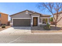 Charming single-story home with a well-manicured front yard and a two-car garage at 28933 N Saddle Way, San Tan Valley, AZ 85143
