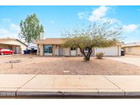 Charming single-story home features a low maintenance front yard and a two car garage at 3227 E Enid Ave, Mesa, AZ 85204