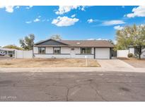 Charming single-story home with a well-maintained front yard and inviting curb appeal at 3330 E Gelding Dr, Phoenix, AZ 85032