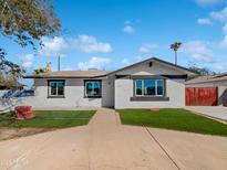 Charming single-story home with well-maintained lawn and inviting curb appeal on a beautiful sunny day at 4644 E Southern Ave, Phoenix, AZ 85042