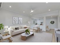 Bright living room featuring neutral color palette, modern décor, and a ceiling fan at 5333 N Las Casitas Pl, Phoenix, AZ 85016