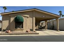 Charming home exterior featuring a covered carport, arched accent, and manicured front garden at 6161 S Pinehurst Dr, Chandler, AZ 85249