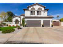 Two-story home featuring a spacious three-car garage and landscaped front yard at 6576 W Lone Cactus Dr, Glendale, AZ 85308
