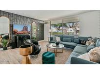 Inviting living room featuring stylish decor, a comfortable sectional, and a large window for ample natural light at 7601 E 2Nd St # 20, Scottsdale, AZ 85251