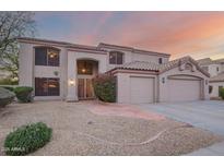 Charming two-story home featuring a three car garage and desert landscaping at 802 N Butte Ave, Chandler, AZ 85226