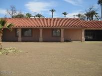 Side view of single story home with a red tile roof and beige exterior walls at 8219 N 59Th Ave, Glendale, AZ 85302