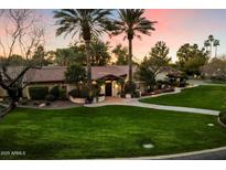Stunning single story home with lush landscaping and a brick walkway to the front door at 8306 N Merion Way, Paradise Valley, AZ 85253