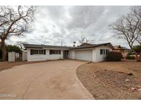 Charming single-story home with a spacious driveway and well-maintained landscaping at 8525 E Keim Dr, Scottsdale, AZ 85250