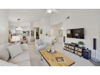 Bright living room featuring vaulted ceilings, modern furnishings, and an open-concept design with kitchen access at 8653 E Royal Palm Rd # 2019, Scottsdale, AZ 85258
