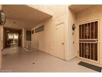 Inviting entrance with decorative door, storage, and warm lighting in a neutral color palette at 19400 N Westbrook Pkwy # 241, Peoria, AZ 85382