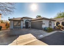 Inviting single-story home featuring a classic design, two-car garage, desert landscaping, and easy street access at 2145 E Danbury Rd, Phoenix, AZ 85022