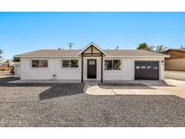 Charming single-story home with a minimalist front yard, white paint, and a modern garage door at 455 E Garfield St, Tempe, AZ 85288