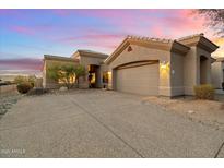 Charming single-story home boasts a beige stucco exterior, tile roof, and attached two car garage at 4744 E Casey Ln, Cave Creek, AZ 85331