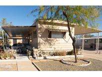 Charming manufactured home with a covered patio and mature landscaping in a well maintained community at 643 S 93Rd St, Mesa, AZ 85208