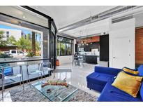 Open-concept living room featuring modern kitchen, seating area, and sleek floors at 7301 E 3Rd Ave # 121, Scottsdale, AZ 85251