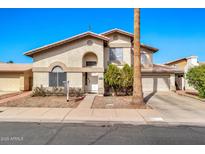 Charming two-story home with desert landscaping, a tile roof, and an attached two-car garage at 1150 E Liberty Shores Dr, Gilbert, AZ 85234