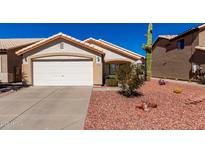 Charming single-story home with a two-car garage and desert landscaping at 2120 E Daley Ln, Phoenix, AZ 85024
